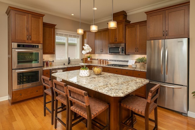 4051 Autumn Lake Ct SW, Rochester, MN 55902 - kitchen with appliances with stainless steel finishes, light wood finished floors, a kitchen breakfast bar, crown molding, and recessed lighting