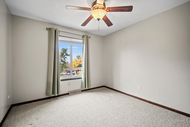 spare room with baseboards, ceiling fan, visible vents, and carpet floors