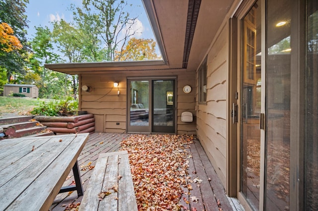 wooden terrace featuring an outbuilding