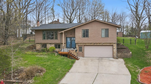 bi-level home featuring a garage, driveway, a chimney, and a shingled roof