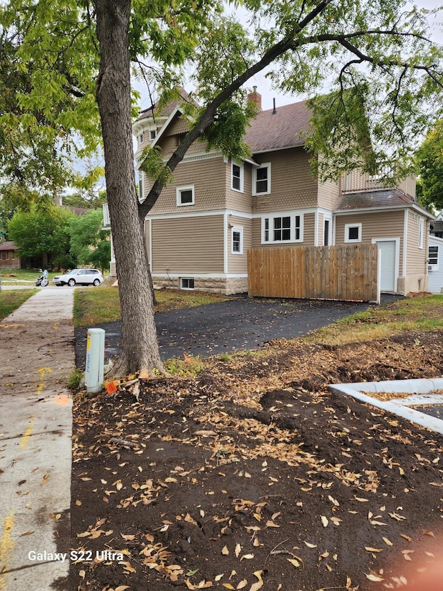 238 Lincoln St, Mankato, MN 56001 - view of home's exterior with roof with shingles, fence, and driveway