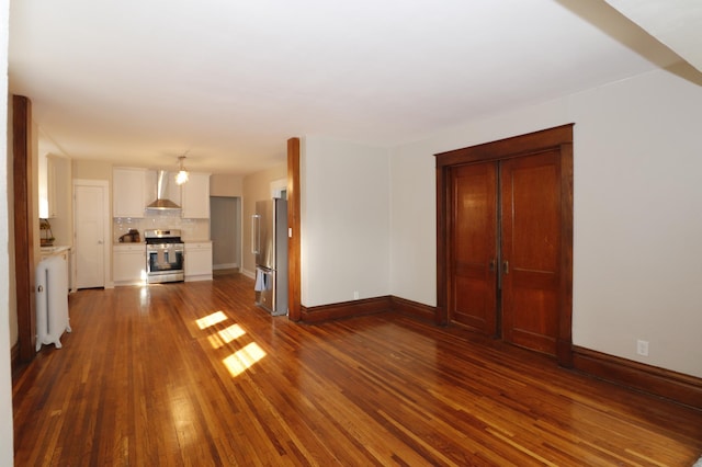 238 Lincoln St, Mankato, MN 56001 - unfurnished living room with dark wood-style flooring and baseboards