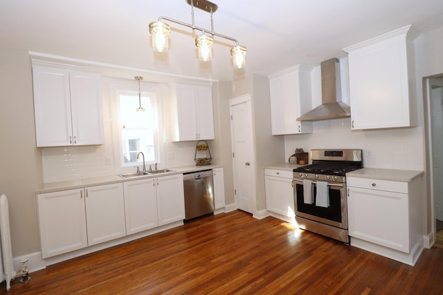 238 Lincoln St, Mankato, MN 56001 - kitchen with white cabinets, appliances with stainless steel finishes, a sink, wall chimney exhaust hood, and decorative backsplash