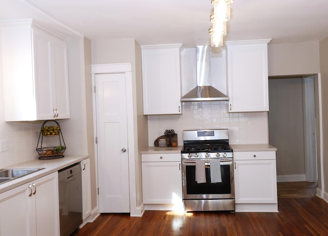 238 Lincoln St, Mankato, MN 56001 - kitchen with decorative backsplash, dark wood-style flooring, appliances with stainless steel finishes, white cabinets, and wall chimney exhaust hood