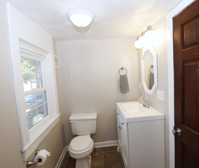 238 Lincoln St, Mankato, MN 56001 - bathroom with baseboards, tile patterned flooring, vanity, and toilet