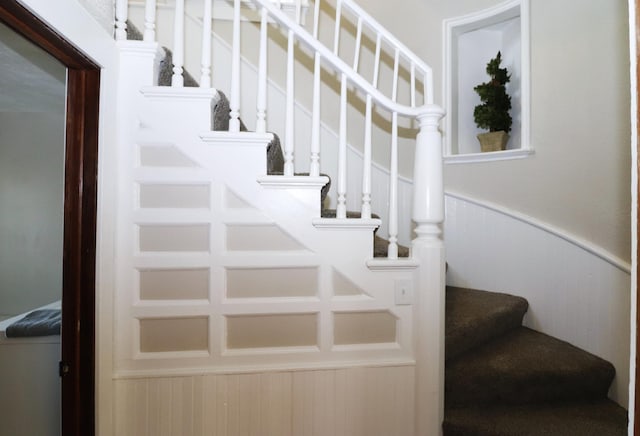 238 Lincoln St, Mankato, MN 56001 - staircase with a decorative wall and a wainscoted wall