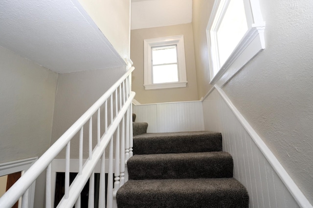238 Lincoln St, Mankato, MN 56001 - staircase featuring a decorative wall and wainscoting