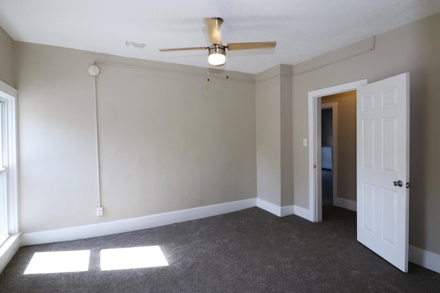 238 Lincoln St, Mankato, MN 56001 - empty room featuring baseboards, ceiling fan, visible vents, and dark carpet