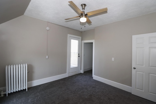 238 Lincoln St, Mankato, MN 56001 - interior space featuring radiator, dark colored carpet, baseboards, a textured ceiling, and a ceiling fan
