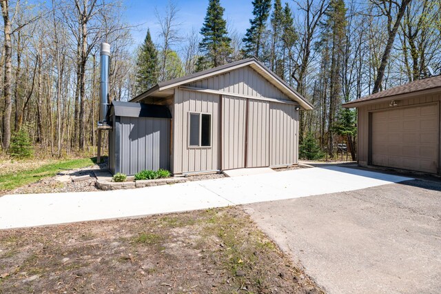 detached garage featuring asphalt driveway