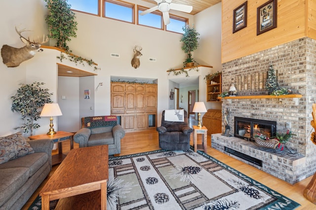 30501 336th Ln, Aitkin, MN 56431 - living area featuring a towering ceiling, ceiling fan, light wood finished floors, and a fireplace