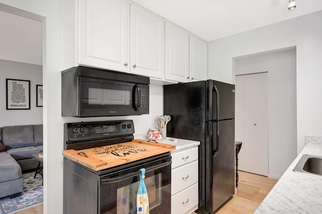 4508 Cedar Lake Rd S Unit 2, Saint Louis Park, MN 55416 - kitchen with light wood-style floors, light countertops, black appliances, and white cabinetry