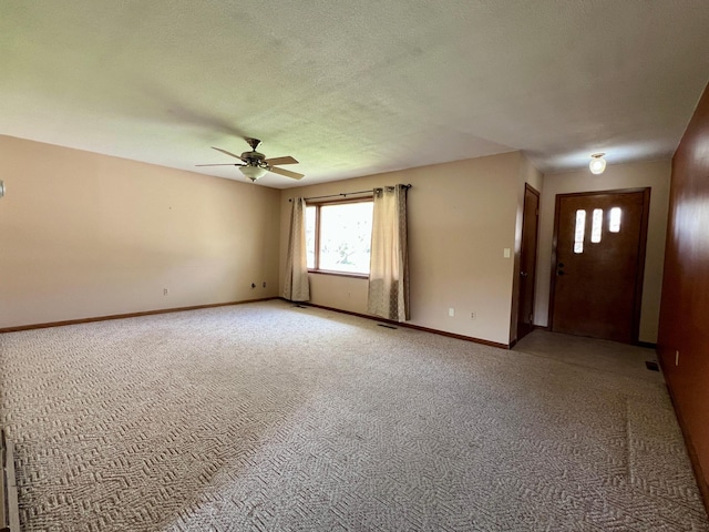 1207 3rd Ave S, Wheaton, MN 56296 - unfurnished living room featuring baseboards, ceiling fan, light colored carpet, and a wealth of natural light