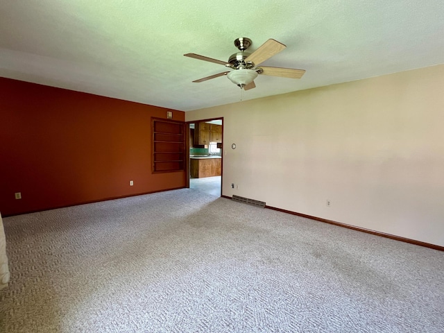 1207 3rd Ave S, Wheaton, MN 56296 - unfurnished room with carpet floors, ceiling fan, visible vents, and baseboards