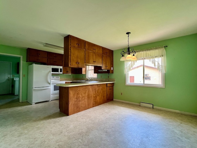 1207 3rd Ave S, Wheaton, MN 56296 - kitchen featuring white appliances, a peninsula, brown cabinetry, and light countertops