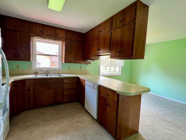 1207 3rd Ave S, Wheaton, MN 56296 - kitchen with dishwasher, a sink, light countertops, a peninsula, and a wealth of natural light