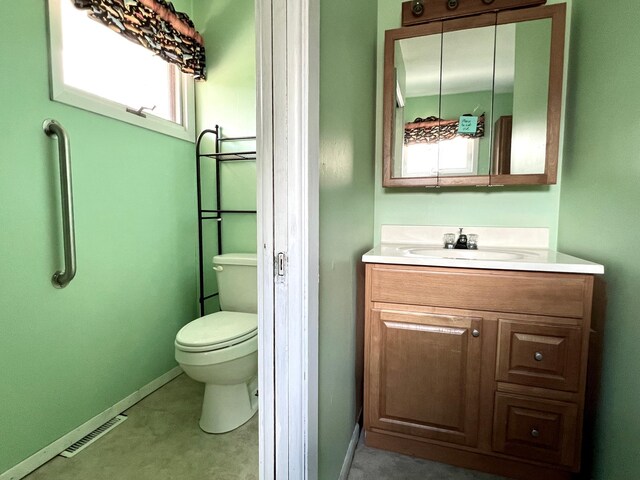 1207 3rd Ave S, Wheaton, MN 56296 - bathroom with baseboards, vanity, toilet, and visible vents