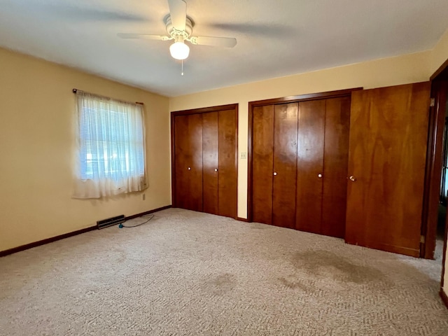 1207 3rd Ave S, Wheaton, MN 56296 - unfurnished bedroom with baseboards, carpet flooring, multiple closets, and ceiling fan