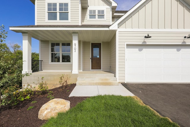 view of front of home featuring a shingled roof, covered porch, and board and batten siding