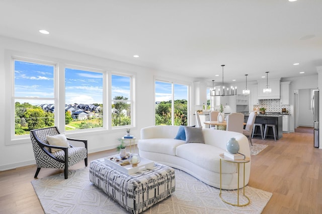 living room with light wood-style floors, baseboards, and recessed lighting