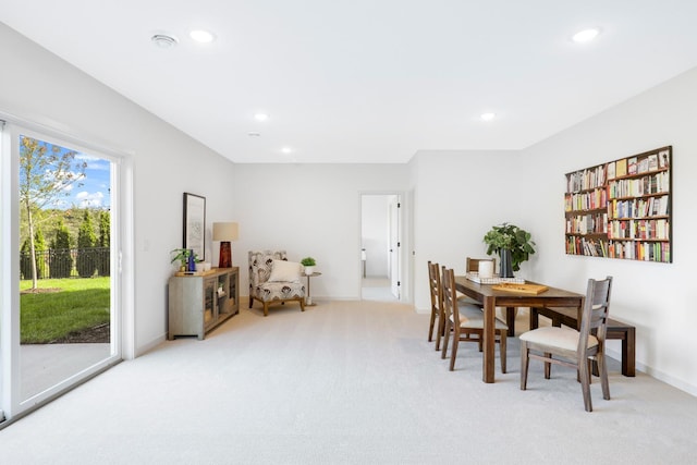 dining space with recessed lighting, baseboards, and light colored carpet