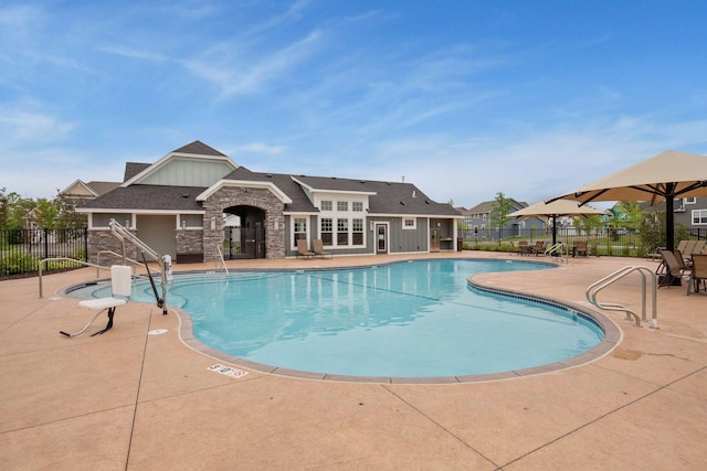 community pool with fence and a patio
