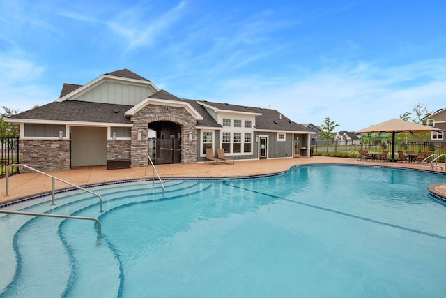 community pool with fence and a patio