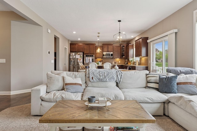 6573 Bridle Path, Corcoran, MN 55340 - living area featuring recessed lighting, wood finished floors, baseboards, and a chandelier