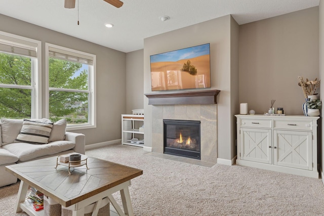 6573 Bridle Path, Corcoran, MN 55340 - living room with carpet flooring, a ceiling fan, baseboards, a tiled fireplace, and recessed lighting