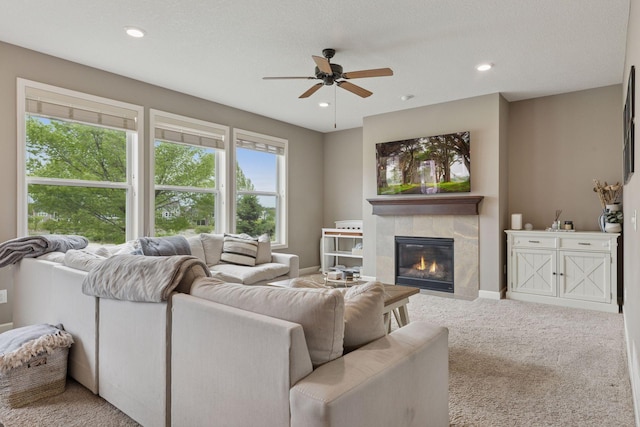 6573 Bridle Path, Corcoran, MN 55340 - living area featuring a ceiling fan, carpet flooring, a tiled fireplace, recessed lighting, and baseboards