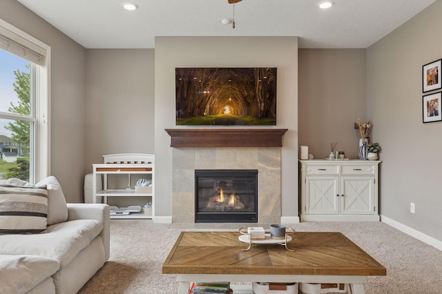 6573 Bridle Path, Corcoran, MN 55340 - carpeted living area with recessed lighting, a tiled fireplace, and baseboards