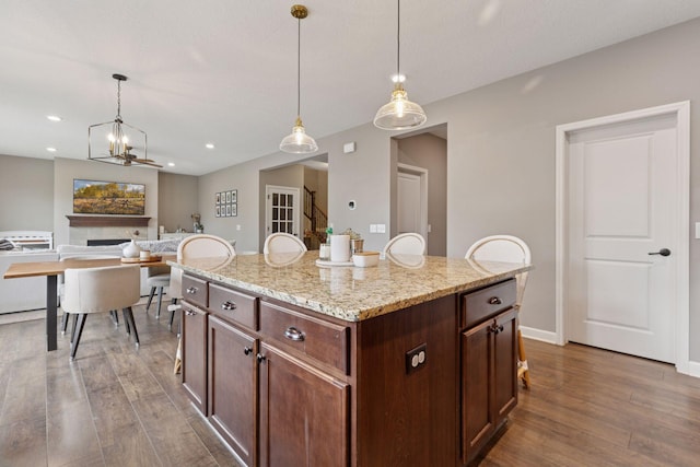 6573 Bridle Path, Corcoran, MN 55340 - kitchen featuring wood finished floors, decorative light fixtures, a kitchen island, and recessed lighting