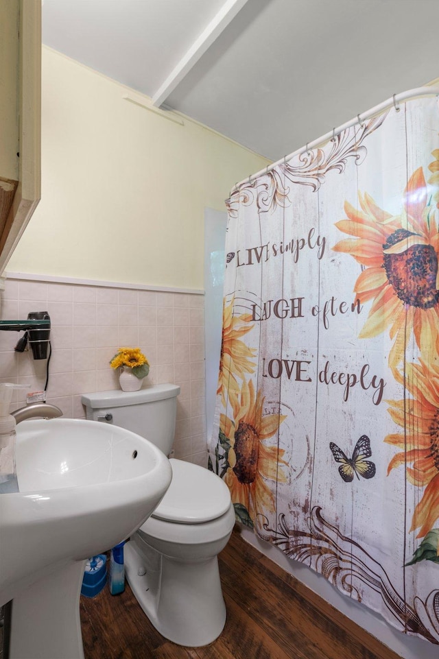 52905 Deerwood Ave, Rush City, MN 55069 - full bath featuring wood finished floors, wainscoting, toilet, a shower with curtain, and tile walls