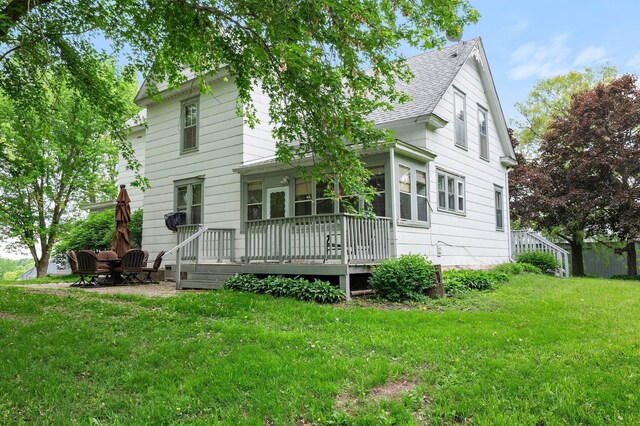 52905 Deerwood Ave, Rush City, MN 55069 - view of front of house with a front yard, roof with shingles, and a wooden deck