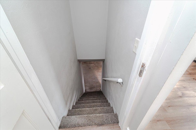 stairs featuring wood finished floors