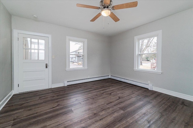 foyer with a healthy amount of sunlight, baseboard heating, and dark wood-style flooring