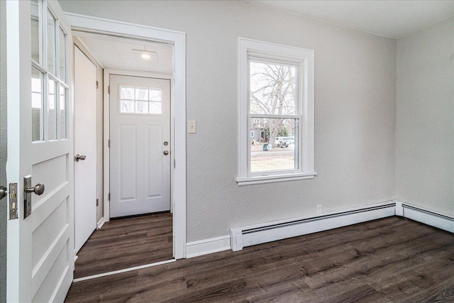 foyer with baseboard heating and dark wood-type flooring