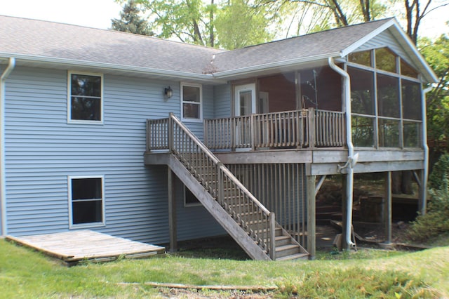 29789 20th Avenue Way, Stanton Twp, MN 55009 - back of property with roof with shingles, a deck, a sunroom, and a lawn