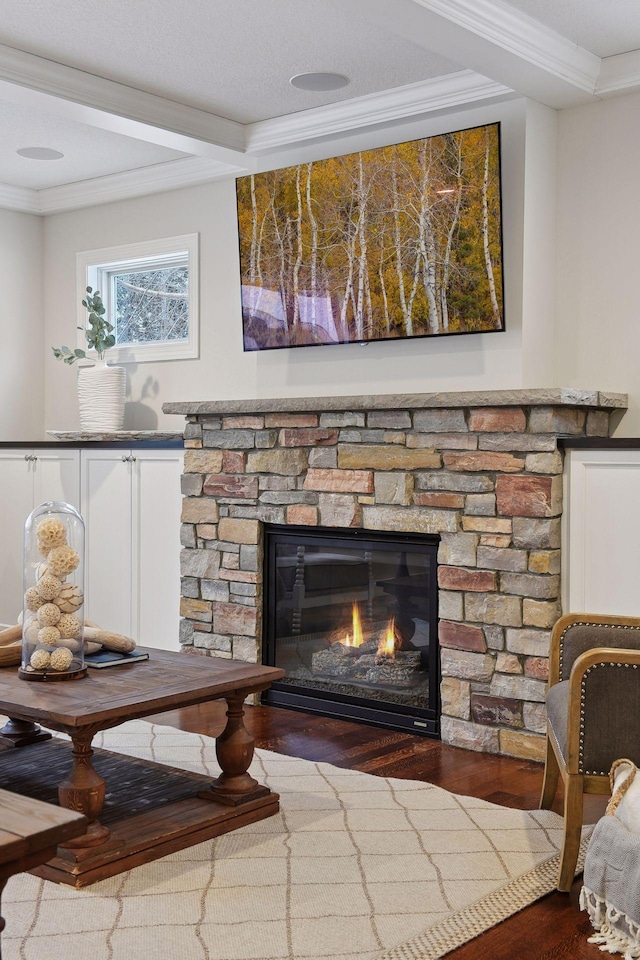 interior details featuring crown molding, a fireplace, wood finished floors, and beam ceiling