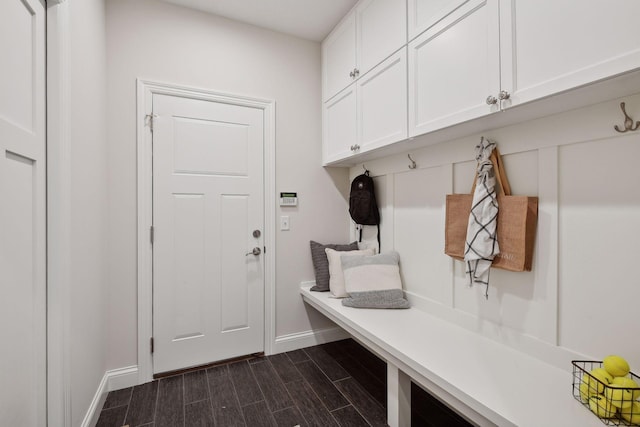 mudroom featuring baseboards and wood finish floors