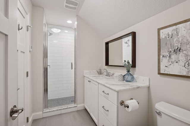 bathroom featuring vanity, tile patterned flooring, a shower stall, and toilet