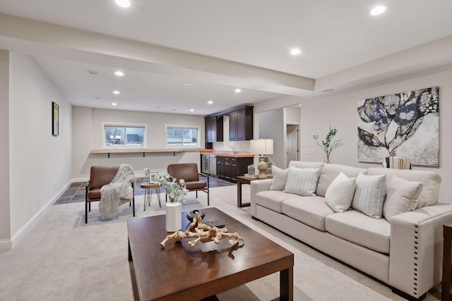 living area with baseboards, light carpet, and recessed lighting