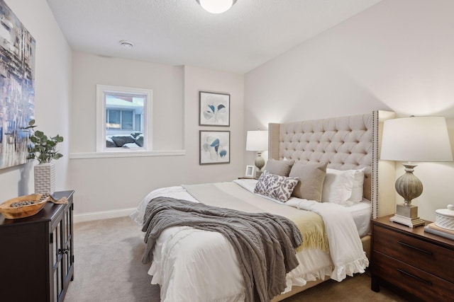 bedroom featuring baseboards and carpet
