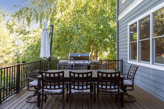 deck featuring outdoor dining space and area for grilling