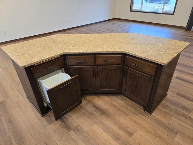 10815 190th Ln NW, Elk River, MN 55330 - kitchen with baseboards, dark brown cabinetry, and light wood-style flooring