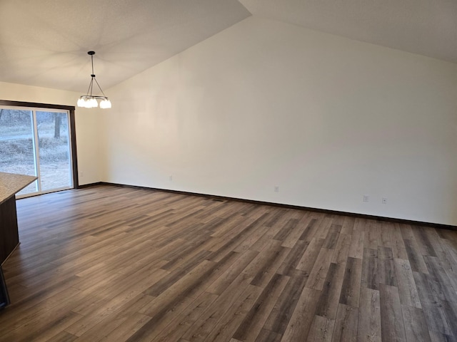 10815 190th Ln NW, Elk River, MN 55330 - unfurnished dining area featuring baseboards, dark wood finished floors, lofted ceiling, and a notable chandelier