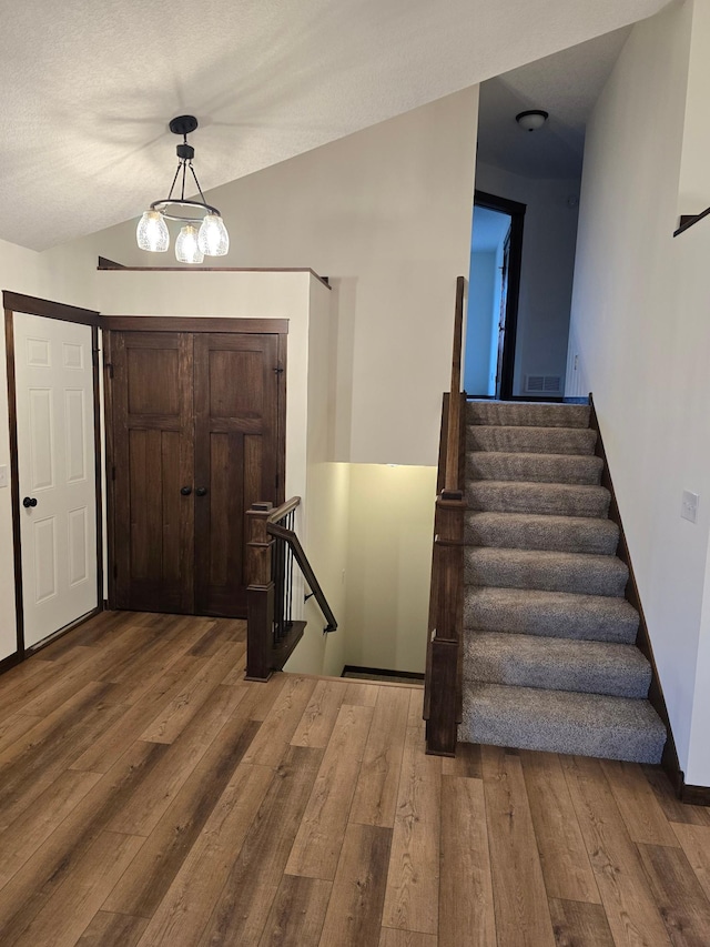 10815 190th Ln NW, Elk River, MN 55330 - foyer entrance featuring wood-type flooring, vaulted ceiling, and stairs