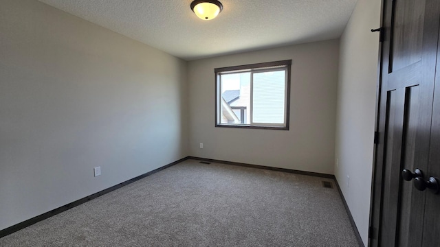 10815 190th Ln NW, Elk River, MN 55330 - carpeted spare room with a textured ceiling, visible vents, and baseboards
