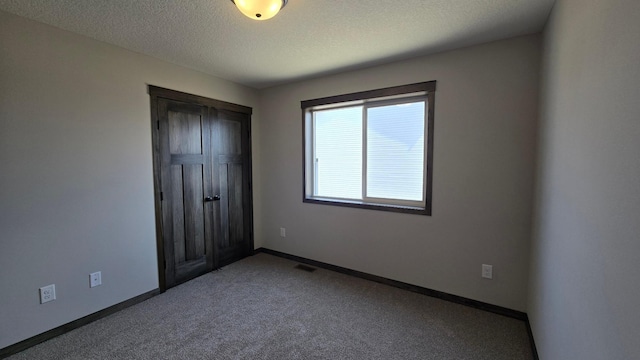 10815 190th Ln NW, Elk River, MN 55330 - unfurnished bedroom featuring carpet flooring, a textured ceiling, baseboards, visible vents, and a closet