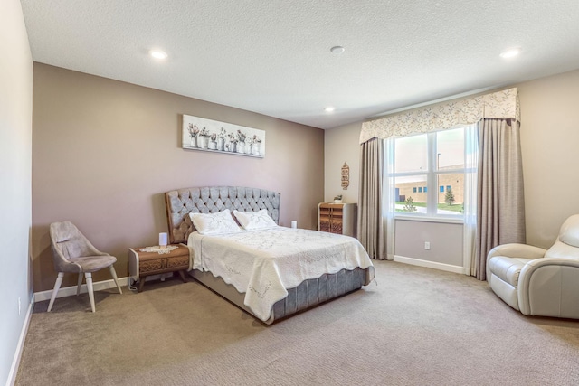bedroom with carpet flooring, recessed lighting, baseboards, and a textured ceiling